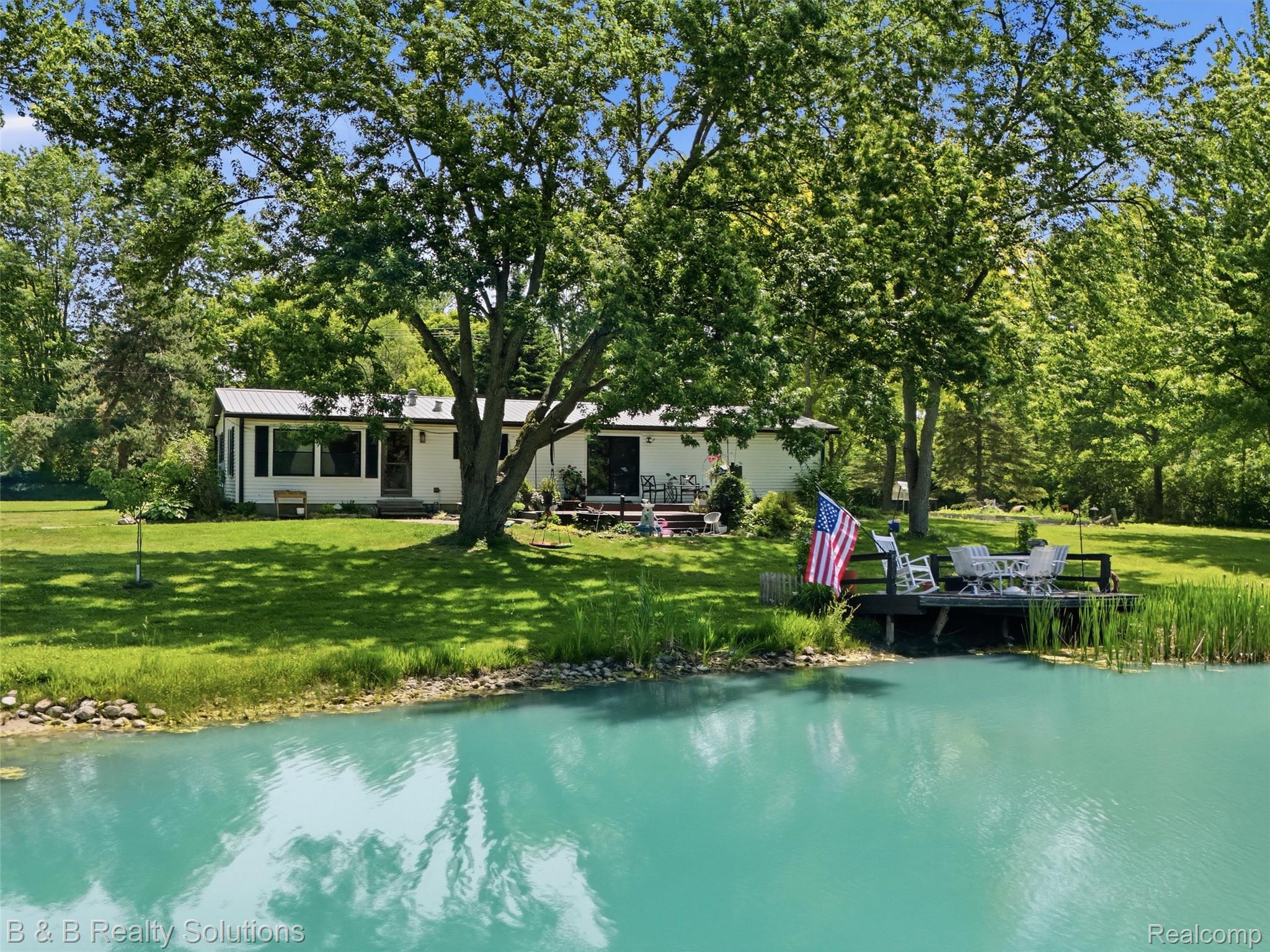 60455 Bates Road New Haven, MI 48048 - Photo 7 of 58 Private pond with a wooden deck featuring a white railing