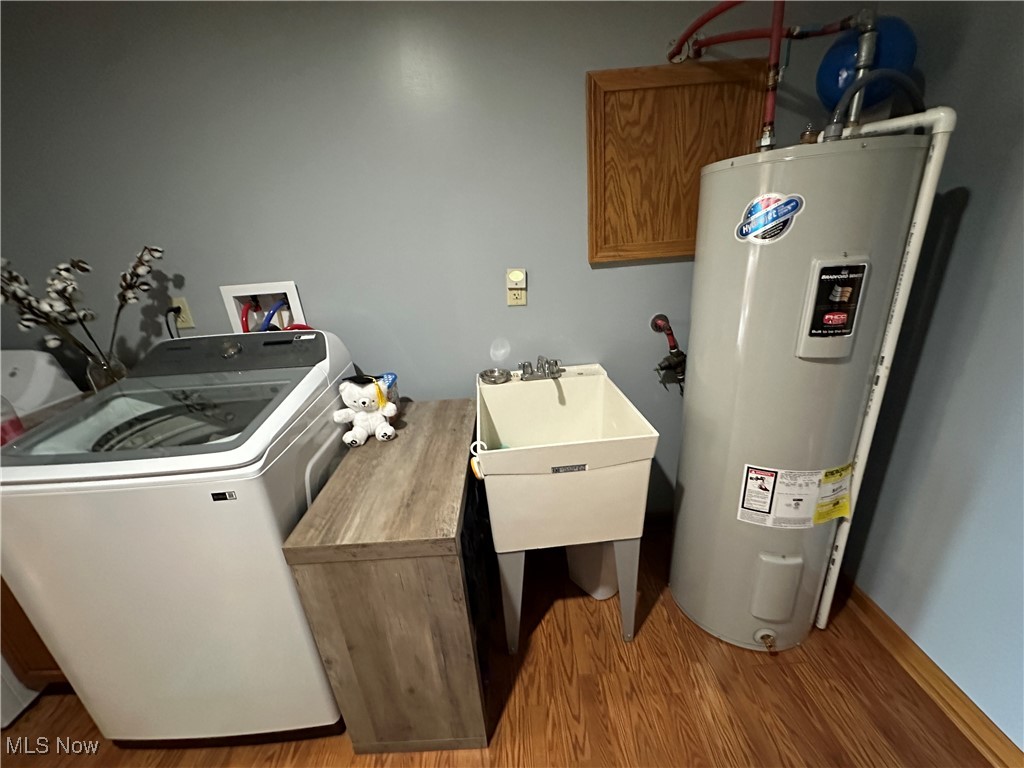 18331 Davis Ridge Road Caldwell, OH 43724 - Photo 20 of 31 Laundry area featuring washer / clothes dryer, water heater, and wood finished floors