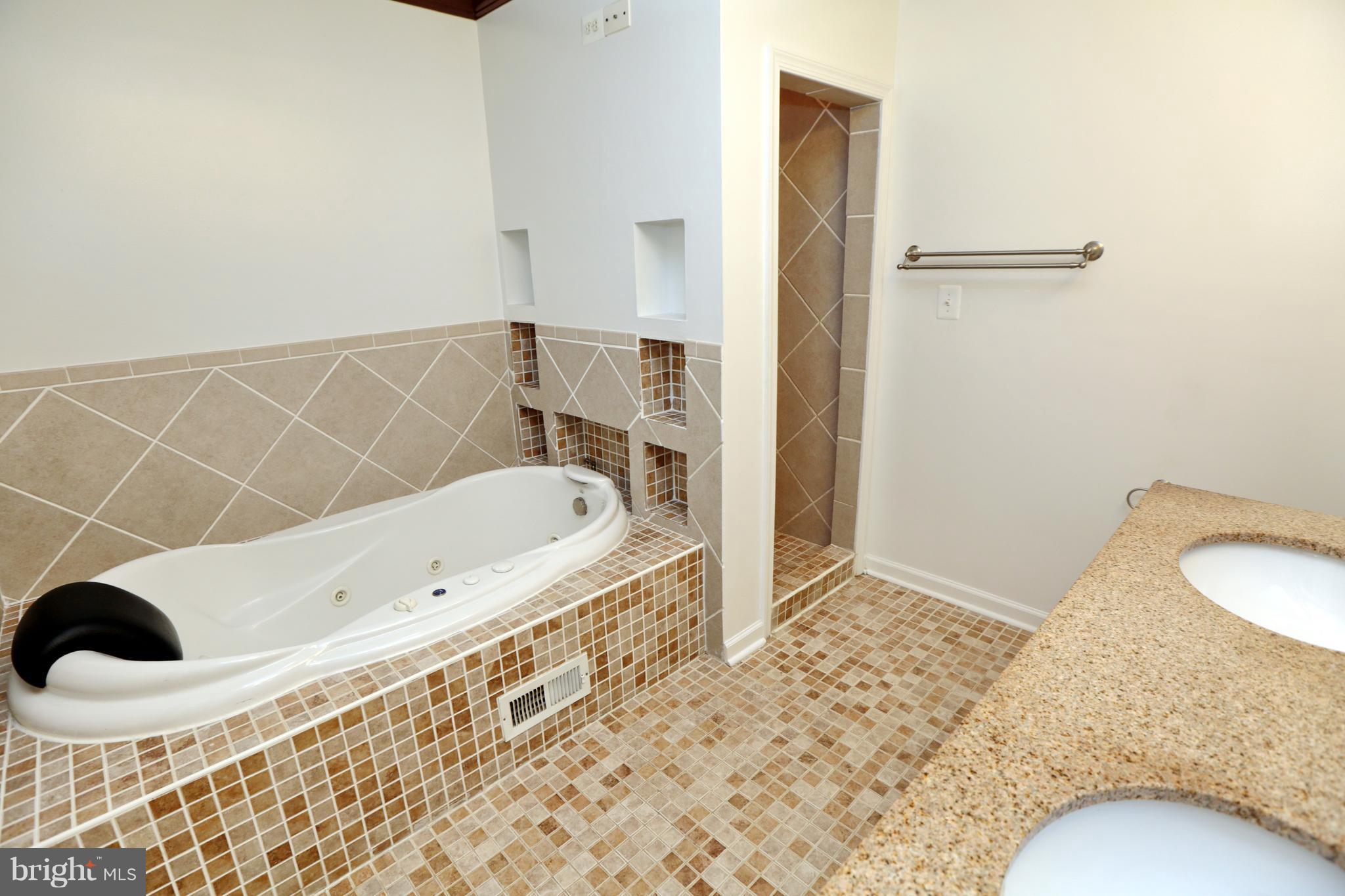 14613 Livingston Road Accokeek, MD 20607 - Photo 14 of 30 a bathroom with a bathtub and shower