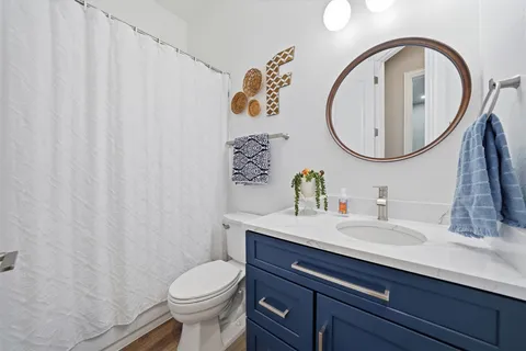 a bathroom with a sink mirror and toilet