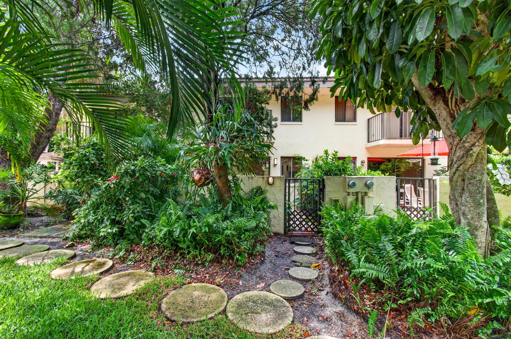 1330 Northwest 13th Street, Unit 12 Boca Raton, FL 33486 - Photo 49 of 52 a backyard of a house with lots of green space