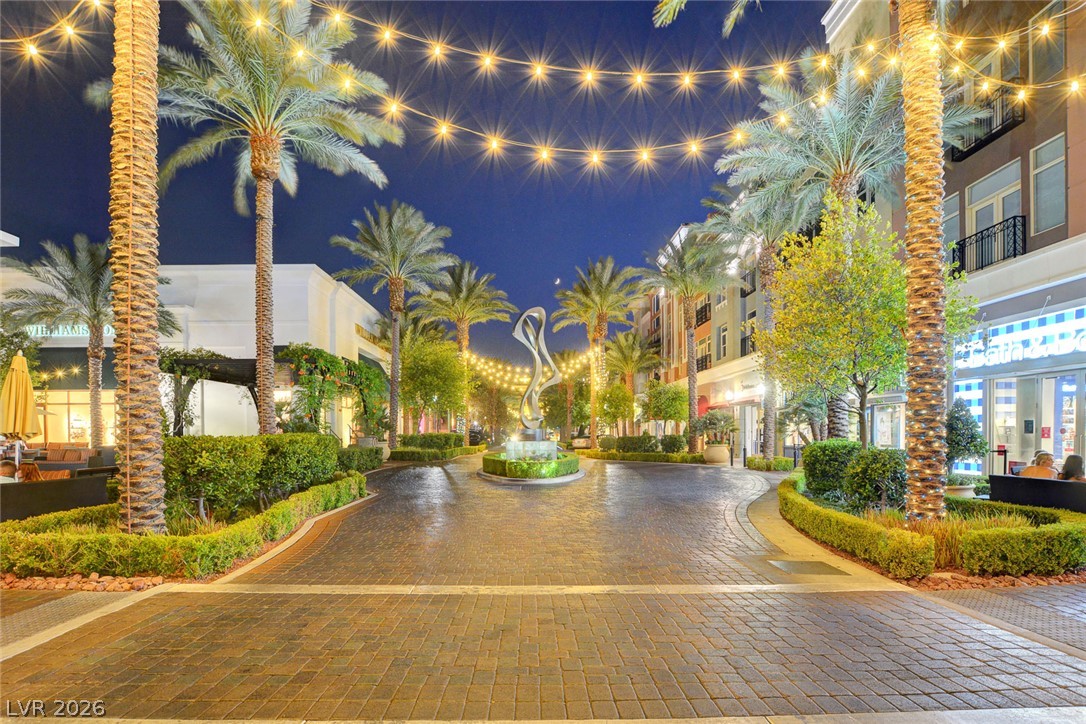 48 Jasmine Point Street Henderson, NV 89074 - Photo 2 of 62 Enter a vibrant community with twinkling lights, lush palms, and inviting street-level establishments.
