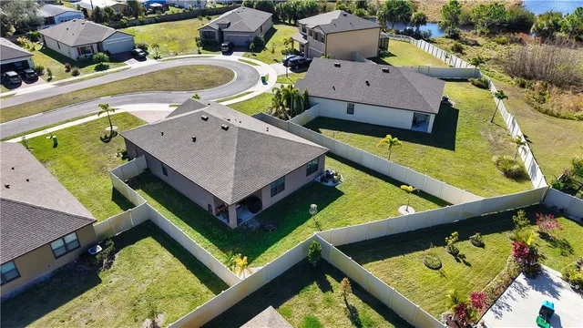 an aerial view of residential houses with outdoor space and swimming pool