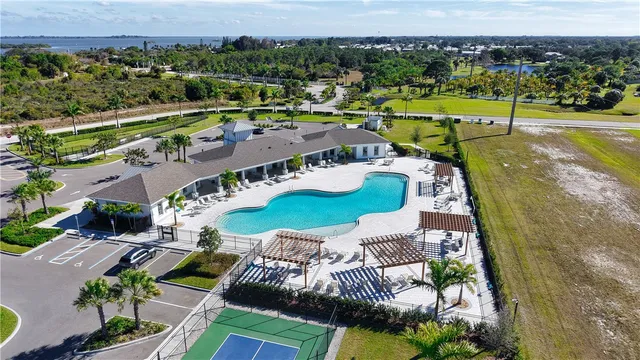 a view of a swimming pool with a yard and sitting space