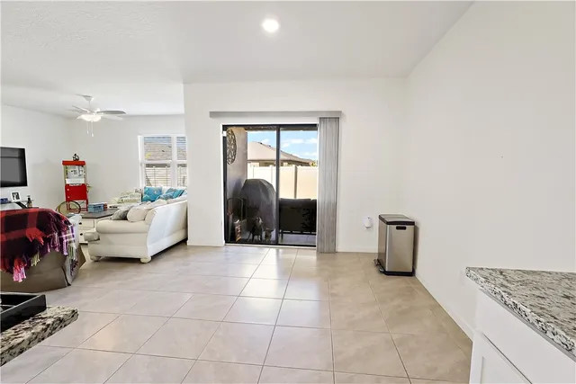 a kitchen with granite countertop a sink and a refrigerator
