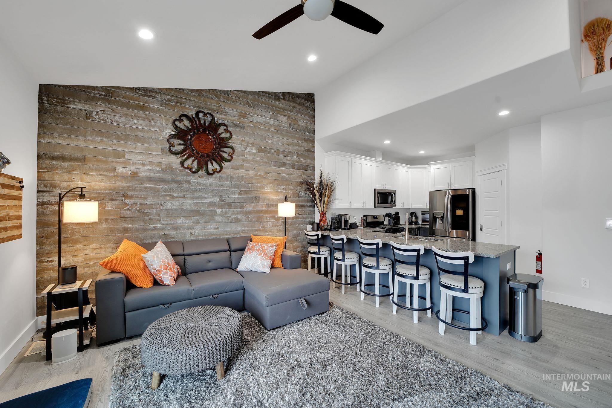 1085 Easy Avenue Twin Falls, ID 83301 - Photo 3 of 22 Living area featuring an accent wall, wooden walls, recessed lighting, ceiling fan, and light wood-style floors