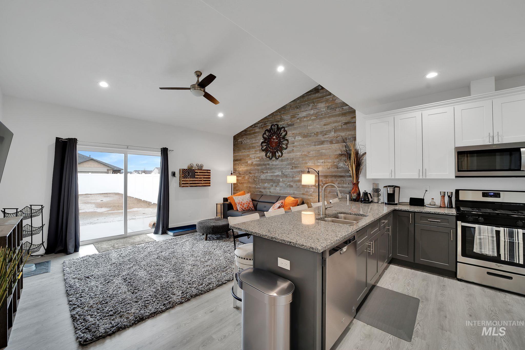 1085 Easy Avenue Twin Falls, ID 83301 - Photo 22 of 22 Kitchen with a peninsula, appliances with stainless steel finishes, light stone counters, white cabinets, and open floor plan