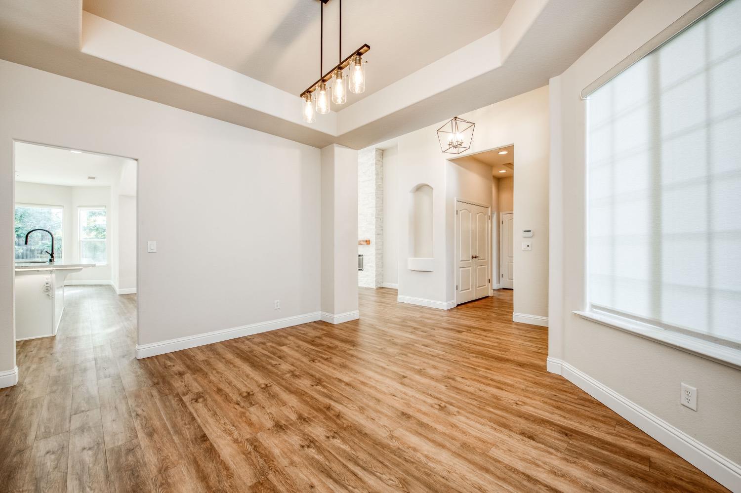 3252 Everglade Avenue Clovis, CA 93619 - Photo 12 of 31 a view of an empty room and window and wooden floor