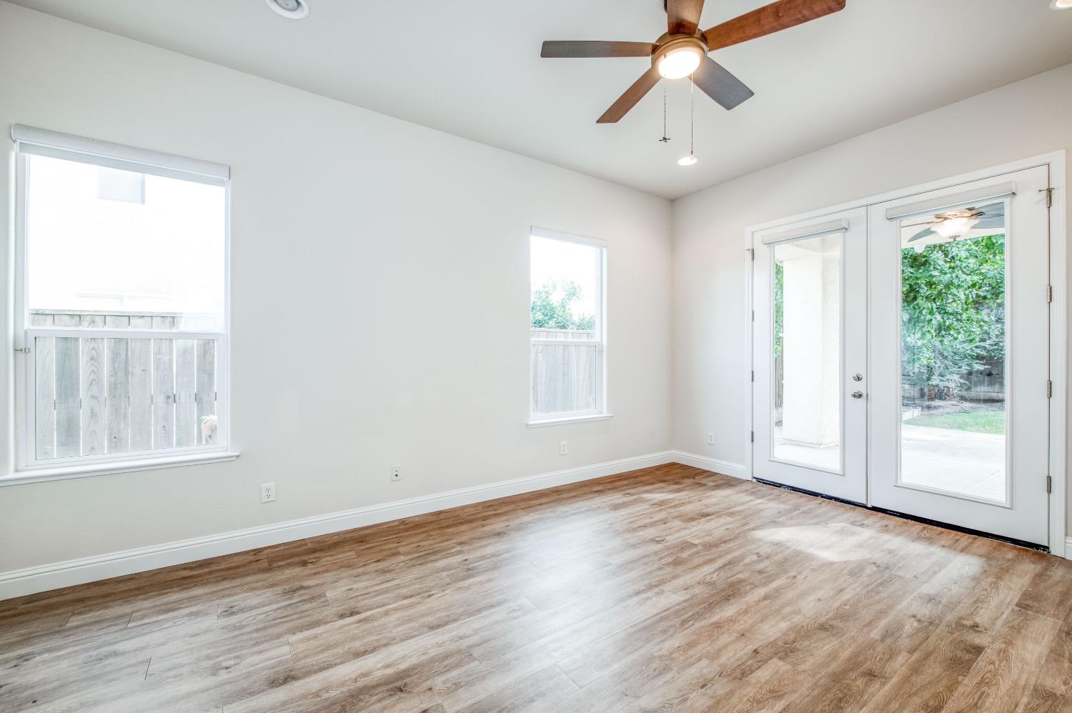 3252 Everglade Avenue Clovis, CA 93619 - Photo 16 of 31 a view of empty room with wooden floor and fan