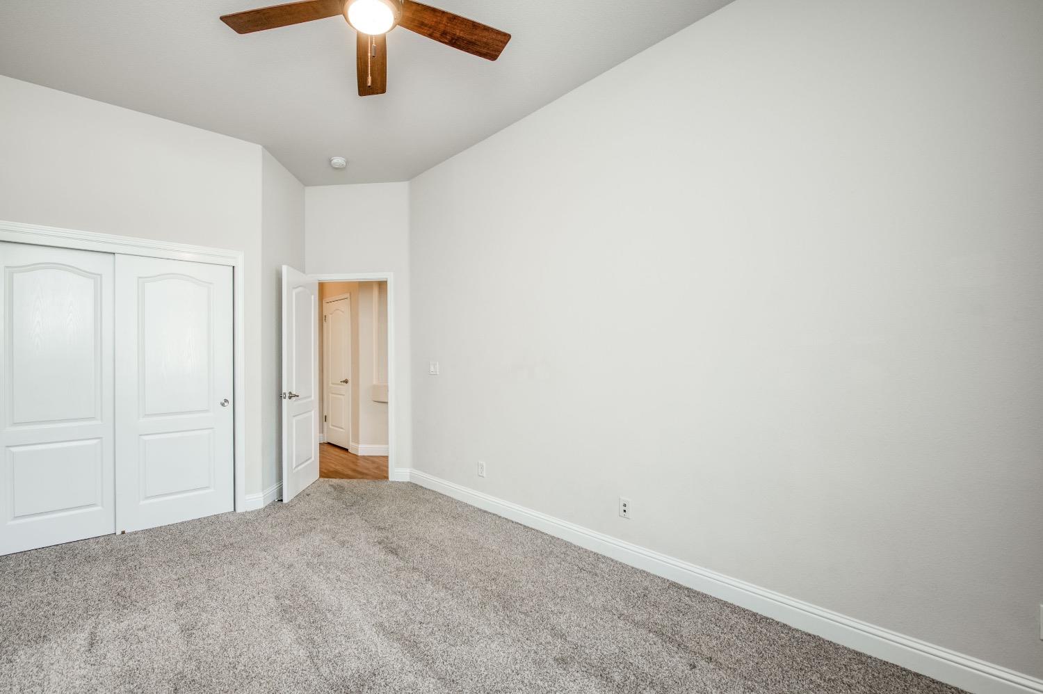 3252 Everglade Avenue Clovis, CA 93619 - Photo 20 of 31 an empty room with a ceiling fan and a window