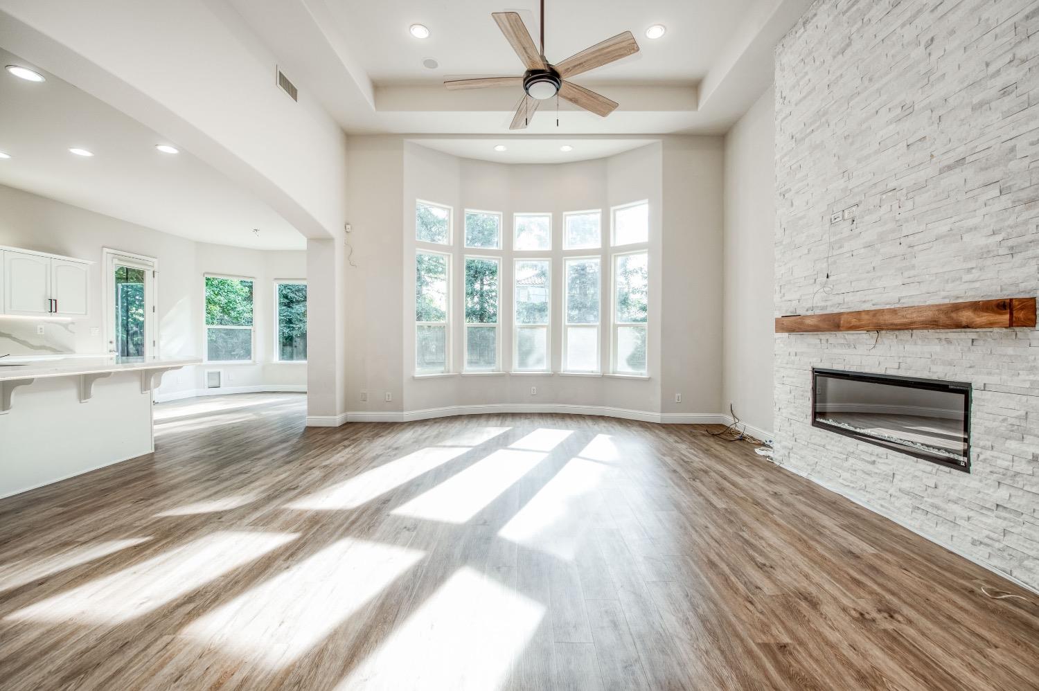 3252 Everglade Avenue Clovis, CA 93619 - Photo 2 of 31 a view of an empty room with wooden floor and a window