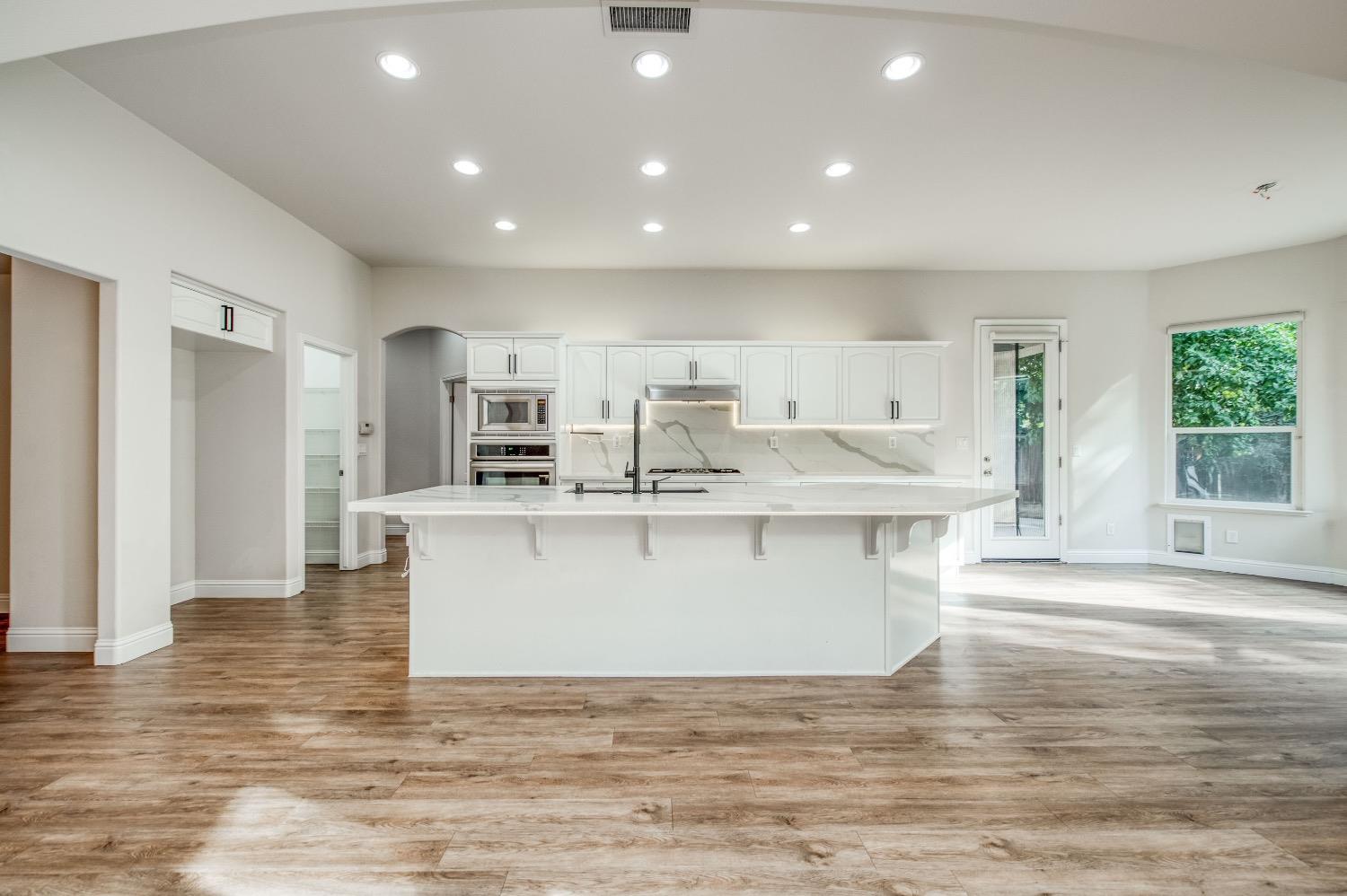 3252 Everglade Avenue Clovis, CA 93619 - Photo 6 of 31 a view of kitchen with stainless steel appliances granite countertop a white stove top oven and white cabinets