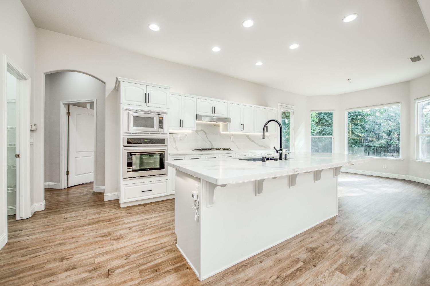 3252 Everglade Avenue Clovis, CA 93619 - Photo 7 of 31 a kitchen with stainless steel appliances granite countertop a sink stove and refrigerator
