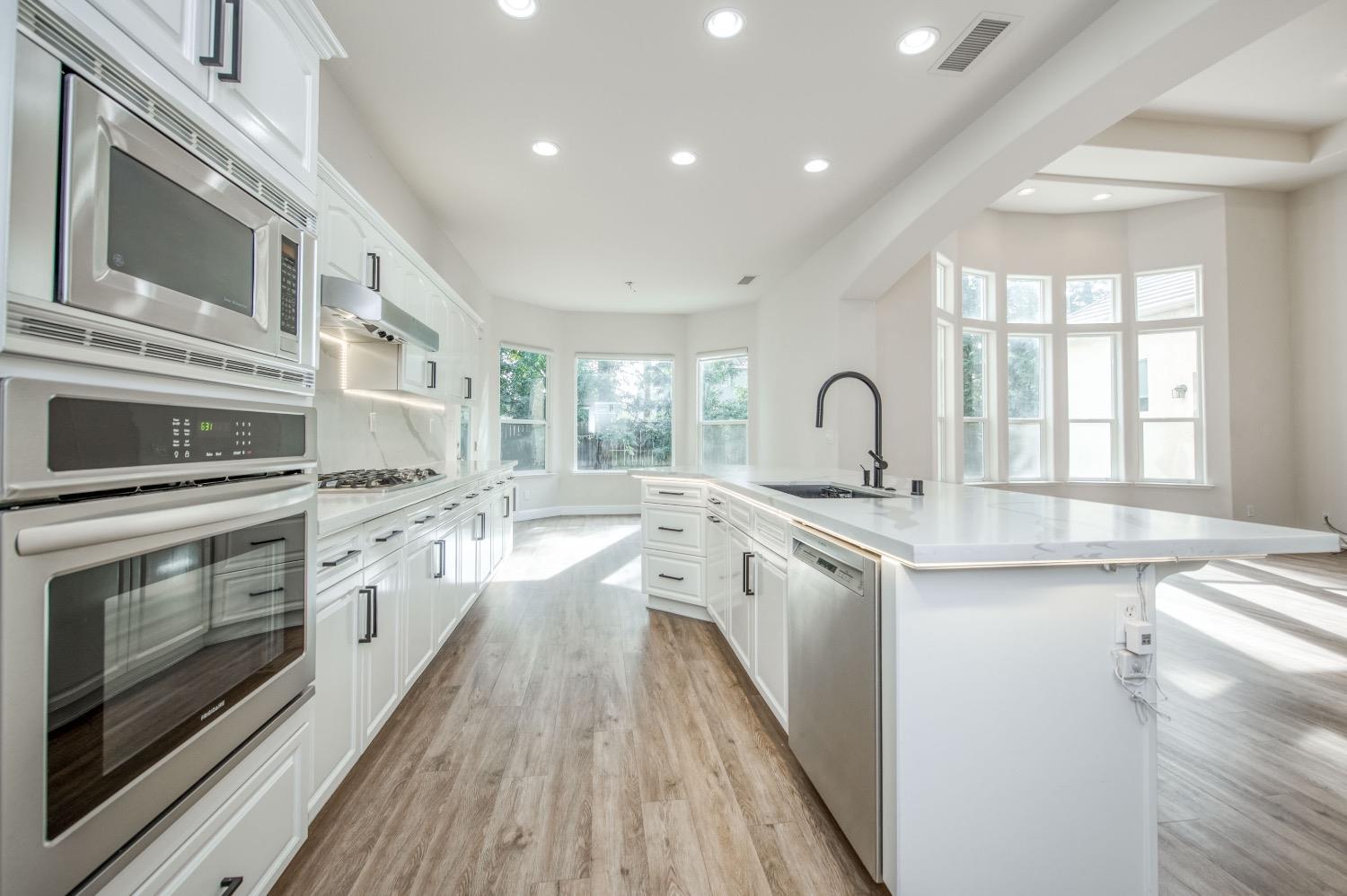 3252 Everglade Avenue Clovis, CA 93619 - Photo 8 of 31 a kitchen with granite countertop a stove and a sink