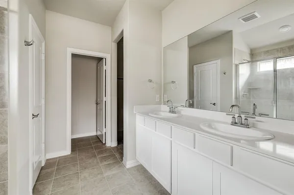 a bathroom with 2 sink and a mirror