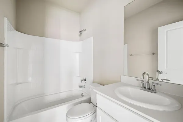 a bathroom with a toilet a sink and bathtub