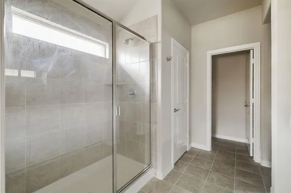 a bathroom with a glass shower door