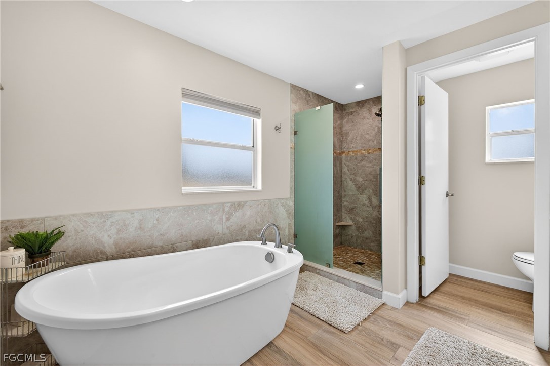 3790 Goggin Road Alva, FL 33920 - Photo 11 of 38 a white bath tub sitting next to a toilet