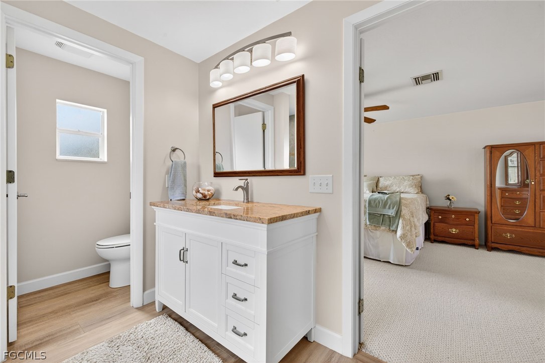 3790 Goggin Road Alva, FL 33920 - Photo 12 of 38 a bathroom with a toilet sink and mirror