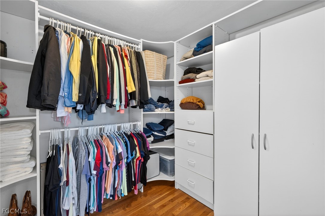 3790 Goggin Road Alva, FL 33920 - Photo 13 of 38 a view of walk in closet with clothes and shoes