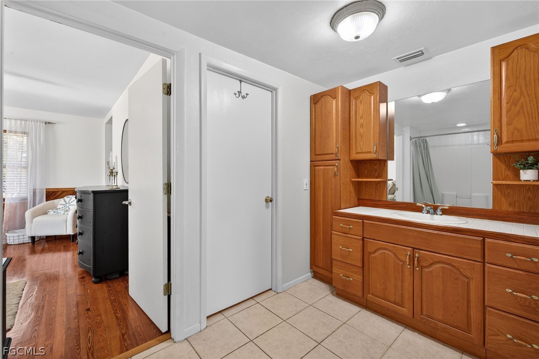 3790 Goggin Road Alva, FL 33920 - Photo 15 of 38 a spacious bathroom with a double vanity sink and a mirror