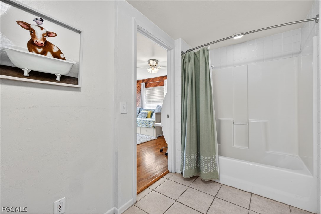 3790 Goggin Road Alva, FL 33920 - Photo 16 of 38 a bathroom with a bathtub and a shower