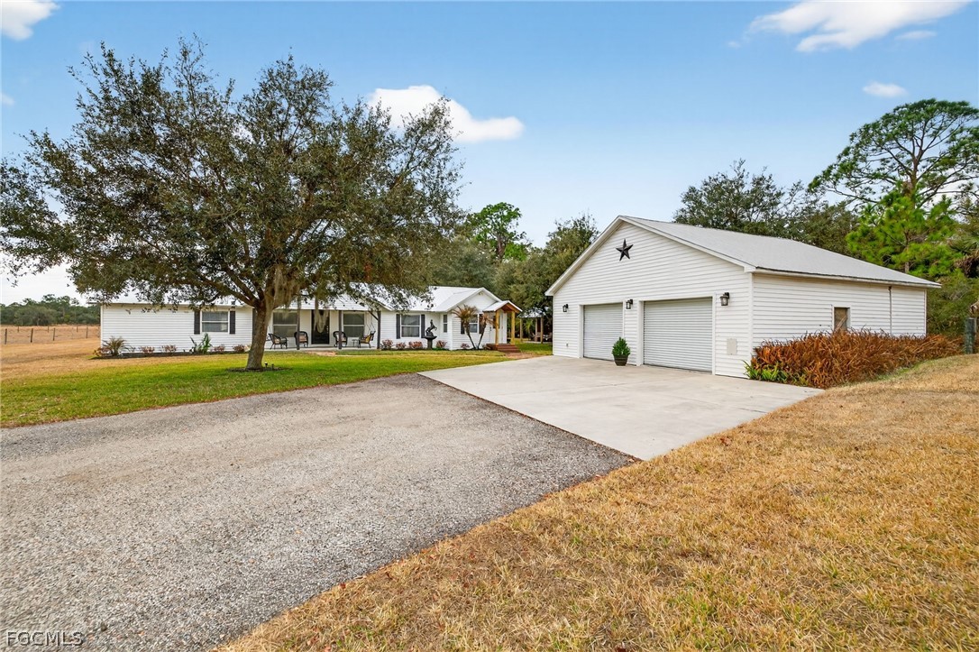 3790 Goggin Road Alva, FL 33920 - Photo 21 of 38 a yellow house with trees in front of it