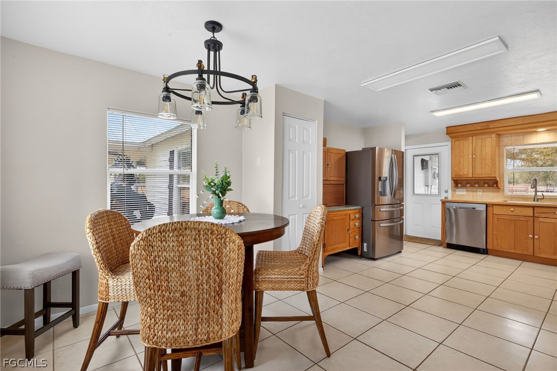 3790 Goggin Road Alva, FL 33920 - Photo 7 of 38 a dining room with furniture a window and kitchen view