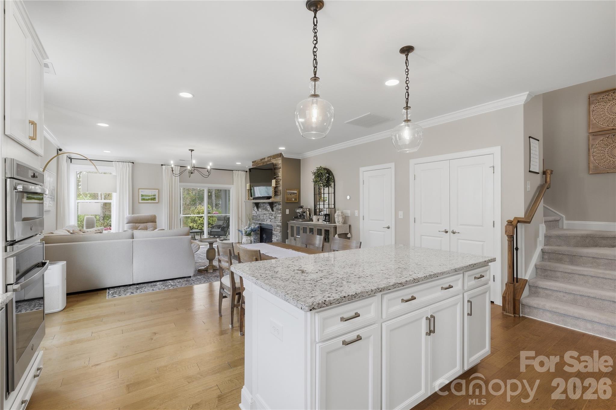 3023 Eagle Ridge Lane Indian Trail, NC 28079 - Photo 12 of 47 a large kitchen with kitchen island a large counter top and stainless steel appliances