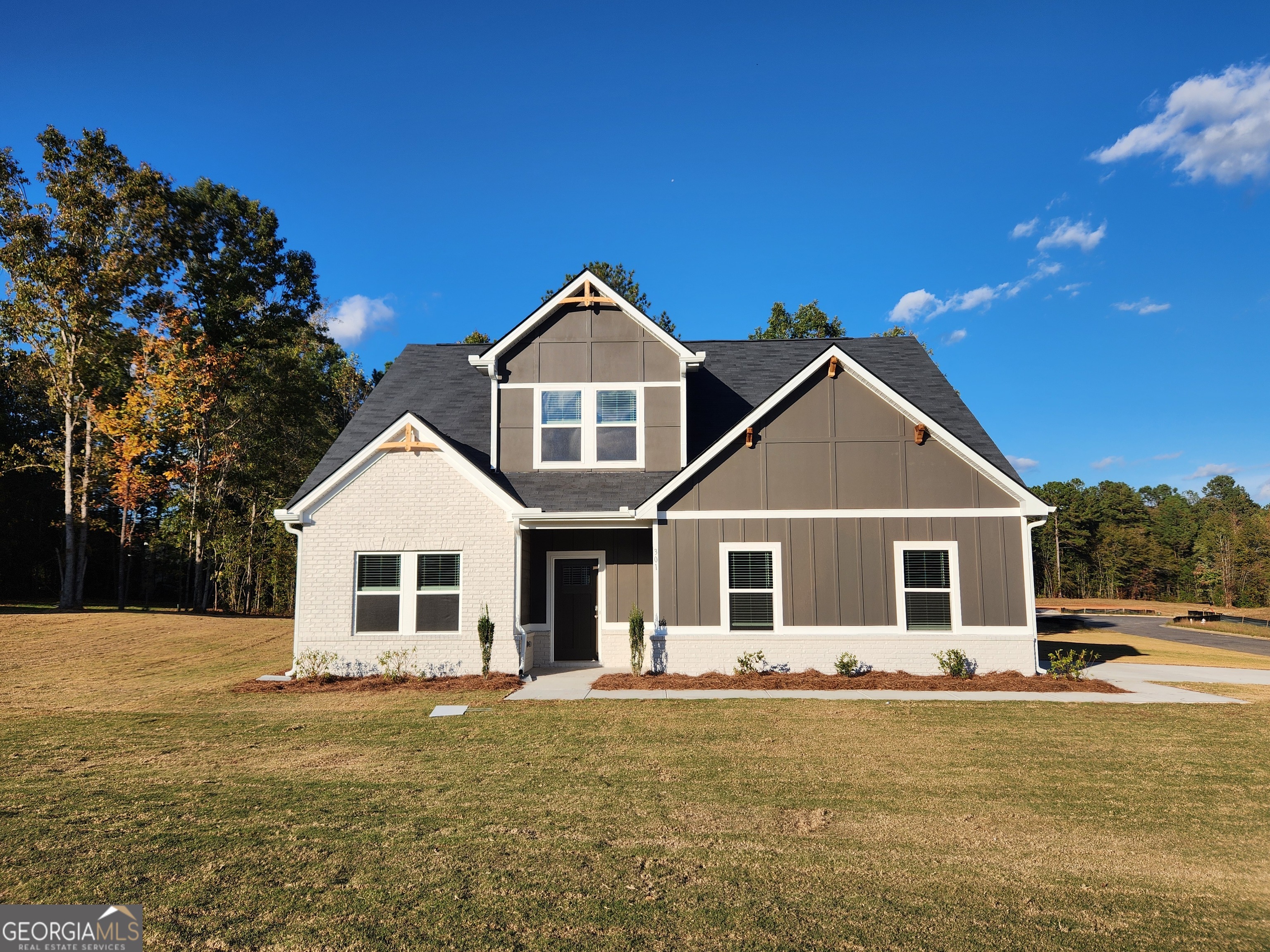 a front view of a house with a garden
