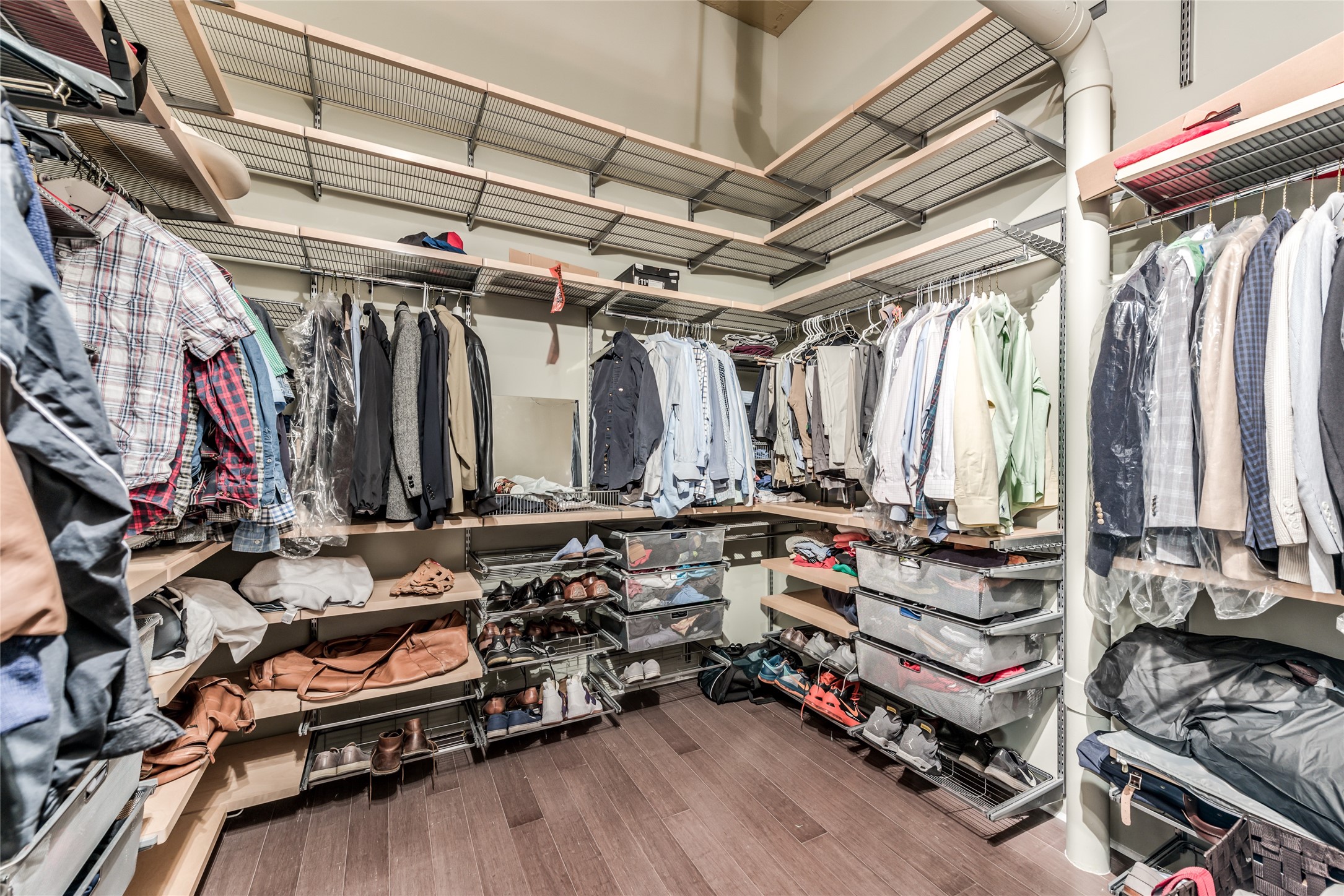 705 Main Street, Unit 215 Houston, TX 77002 - Photo 26 of 36 This spacious walk-in closet features ample shelving and hanging space, perfect for organizing clothing and accessories.