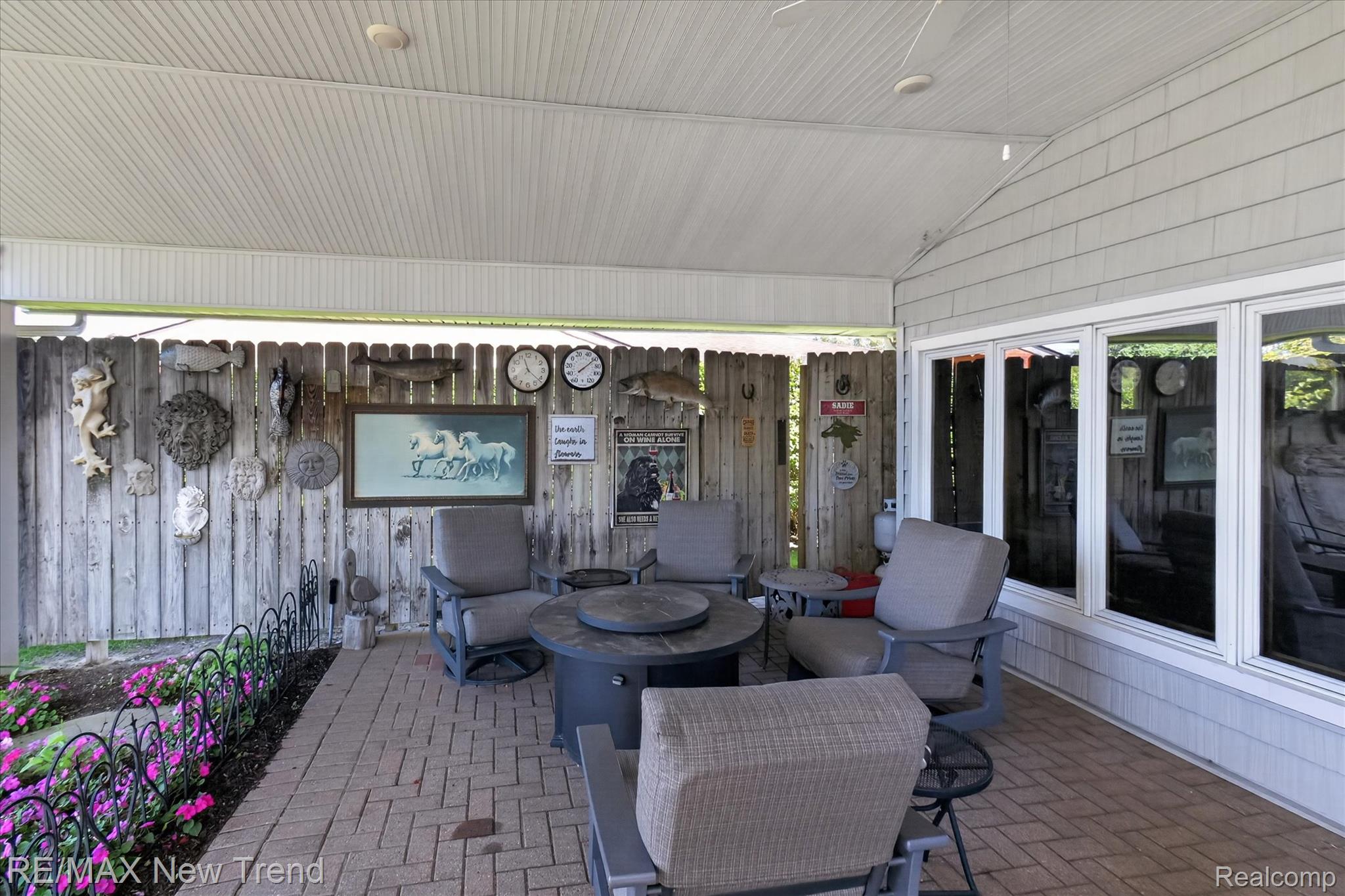 2529 South Commerce Road Walled Lake, MI 48390 - Photo 50 of 66 Covered patio with a brick paver surface, a white paneled ceiling, and multiple windows