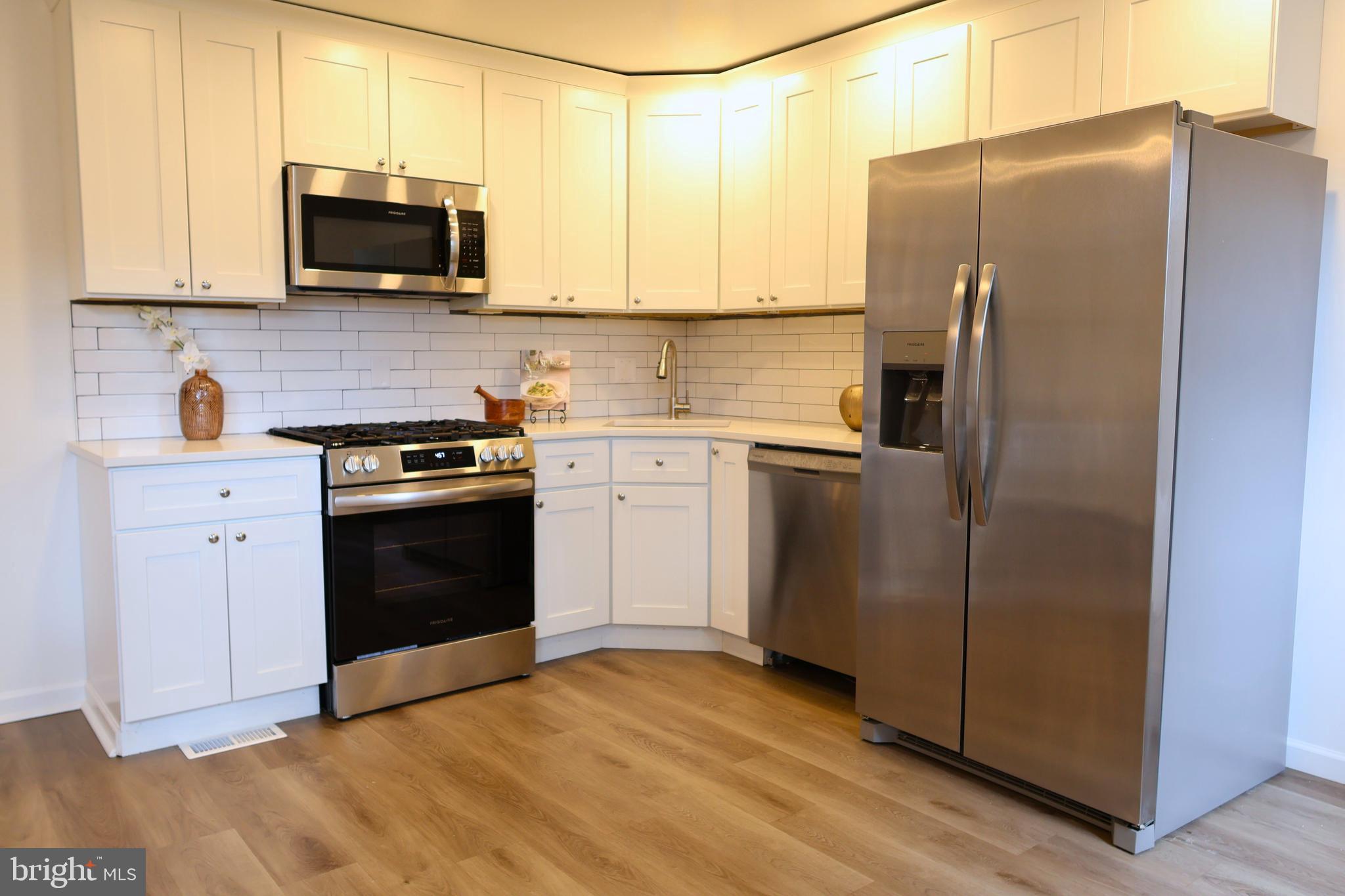3920 Elson Road Brookhaven, PA 19015 - Photo 6 of 31 a kitchen with stainless steel appliances granite countertop a refrigerator stove and microwave