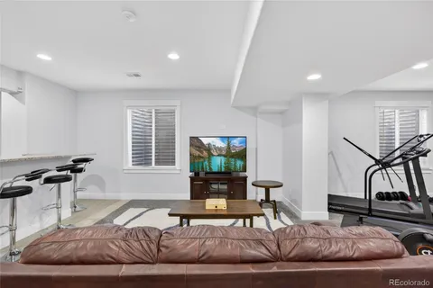 a living room with furniture gym equipment and a view of living room