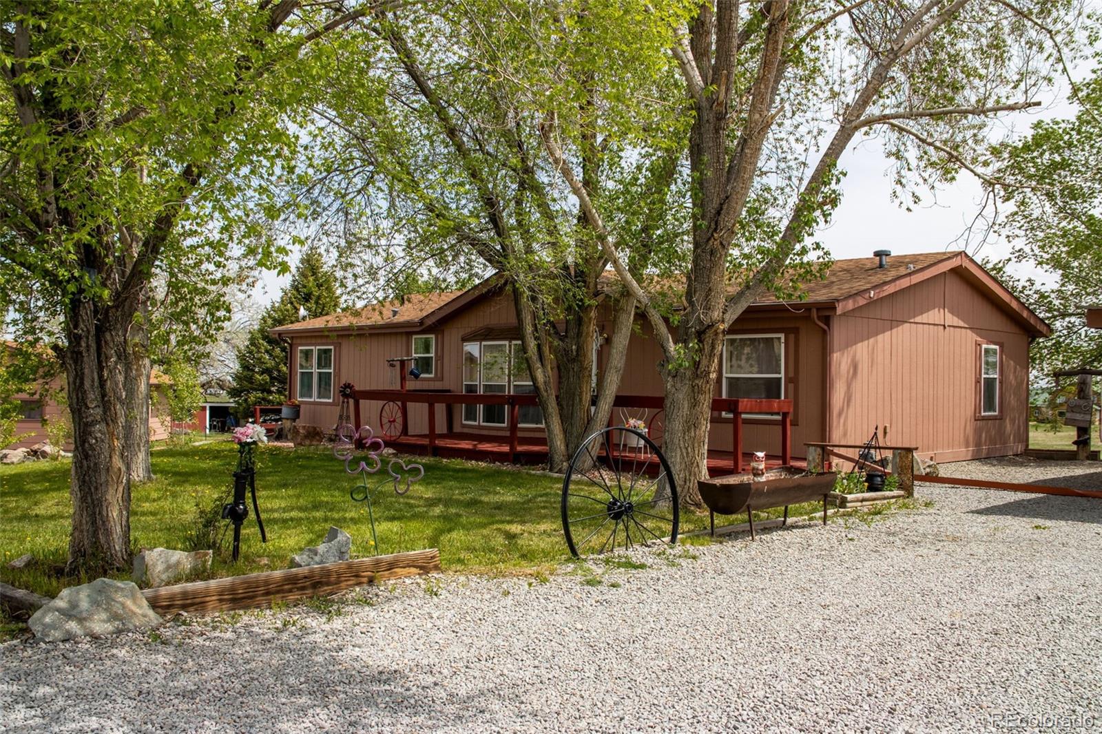 6310 West Co Road 4 Berthoud, CO 80513 - Photo 11 of 49 a view of a house with backyard and a tree