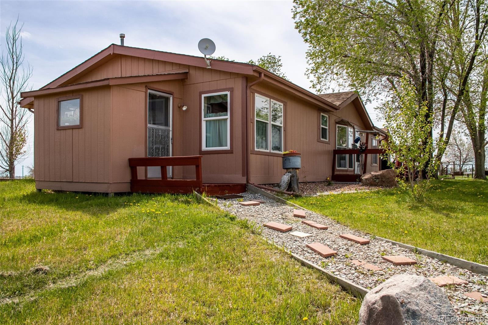 6310 West Co Road 4 Berthoud, CO 80513 - Photo 13 of 49 a front view of a house with garden