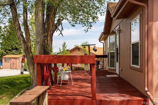 a view of a patio with table and chairs with wooden fence and floor