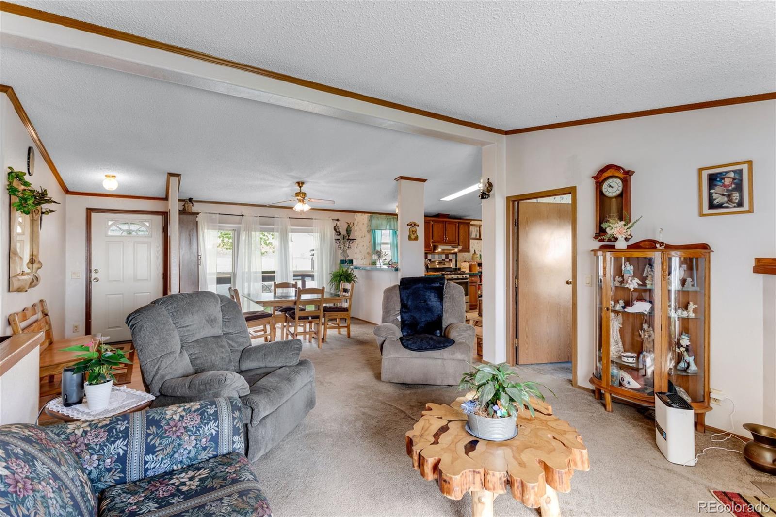 6310 West Co Road 4 Berthoud, CO 80513 - Photo 19 of 49 a living room with furniture fireplace and a large window
