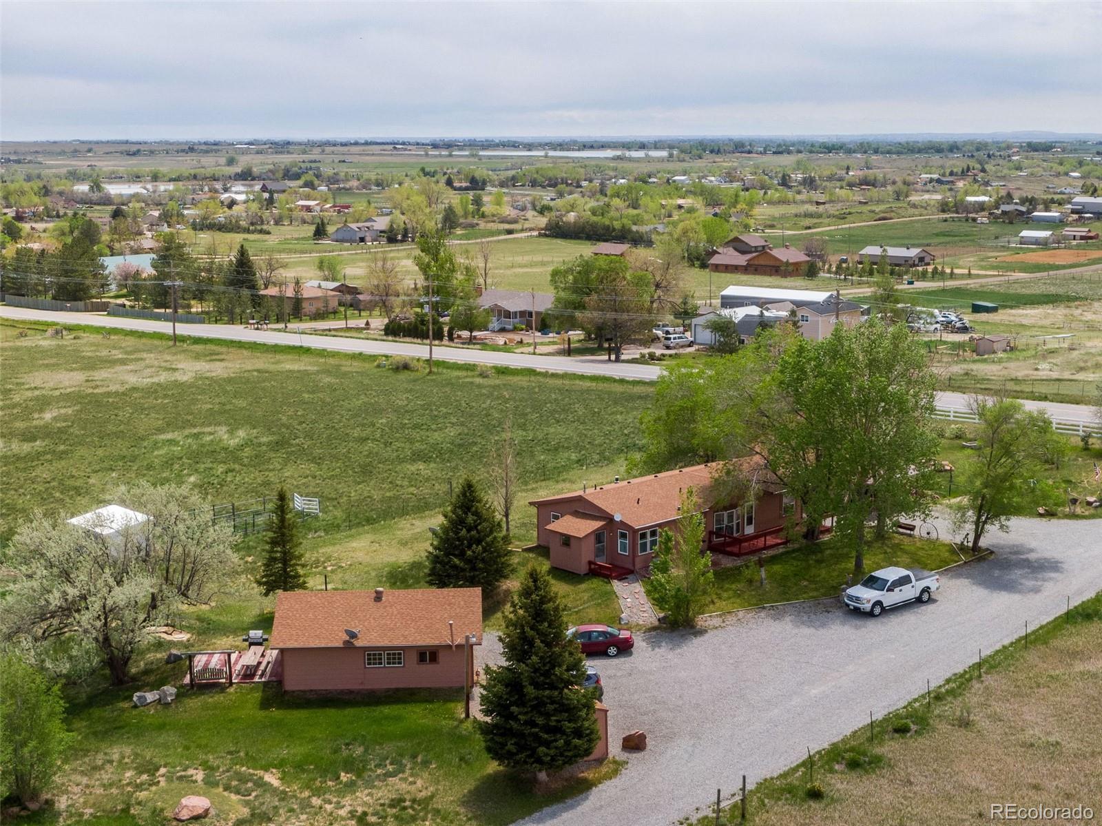 6310 West Co Road 4 Berthoud, CO 80513 - Photo 2 of 49 an aerial view of residential houses with outdoor space