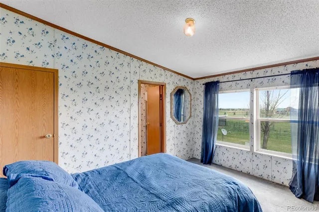 a bedroom with a bed and a window with outer view