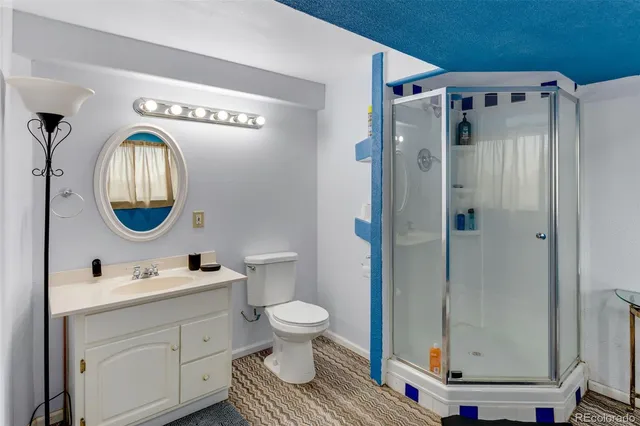 a bathroom with a toilet a sink and a mirror