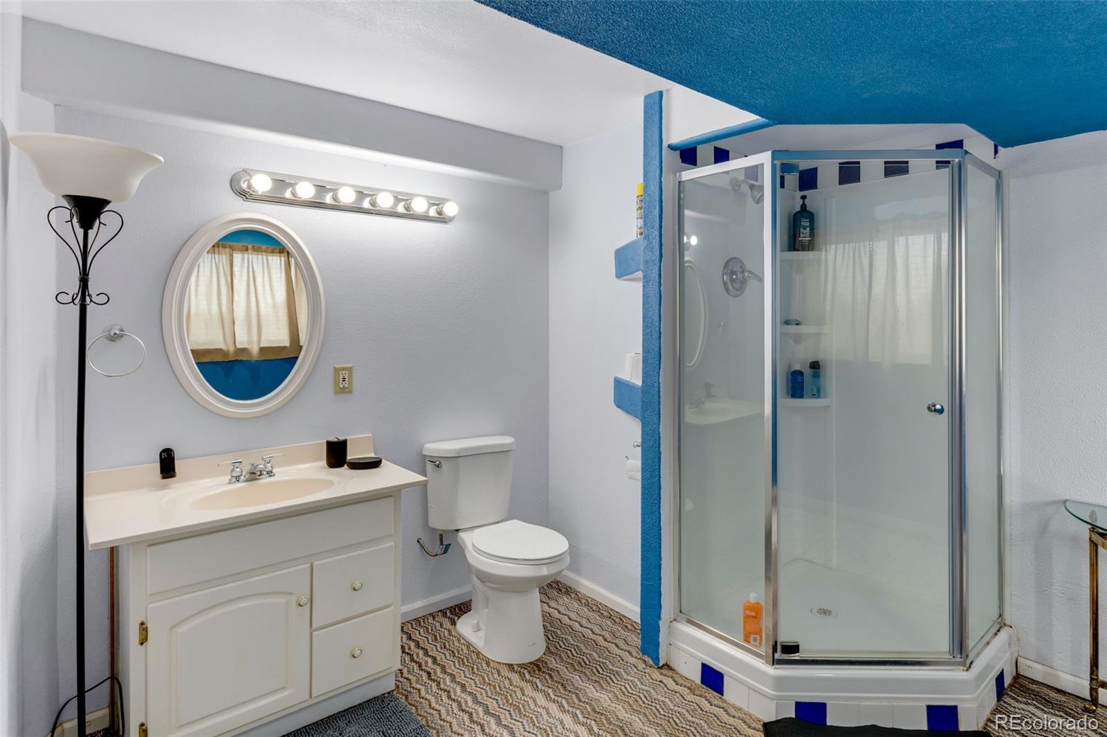 6310 West Co Road 4 Berthoud, CO 80513 - Photo 26 of 49 a bathroom with a toilet a sink and a mirror