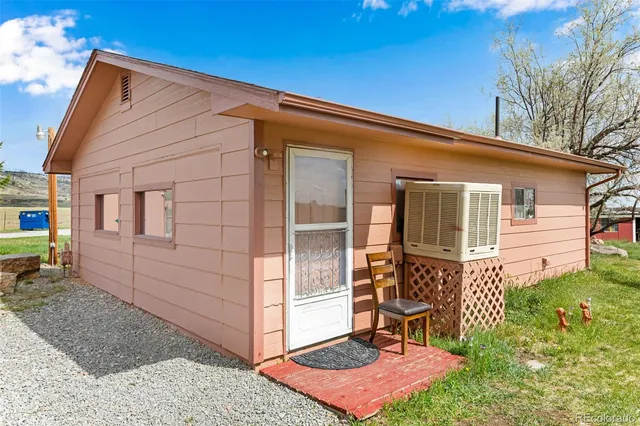a backyard of a house with table and chairs