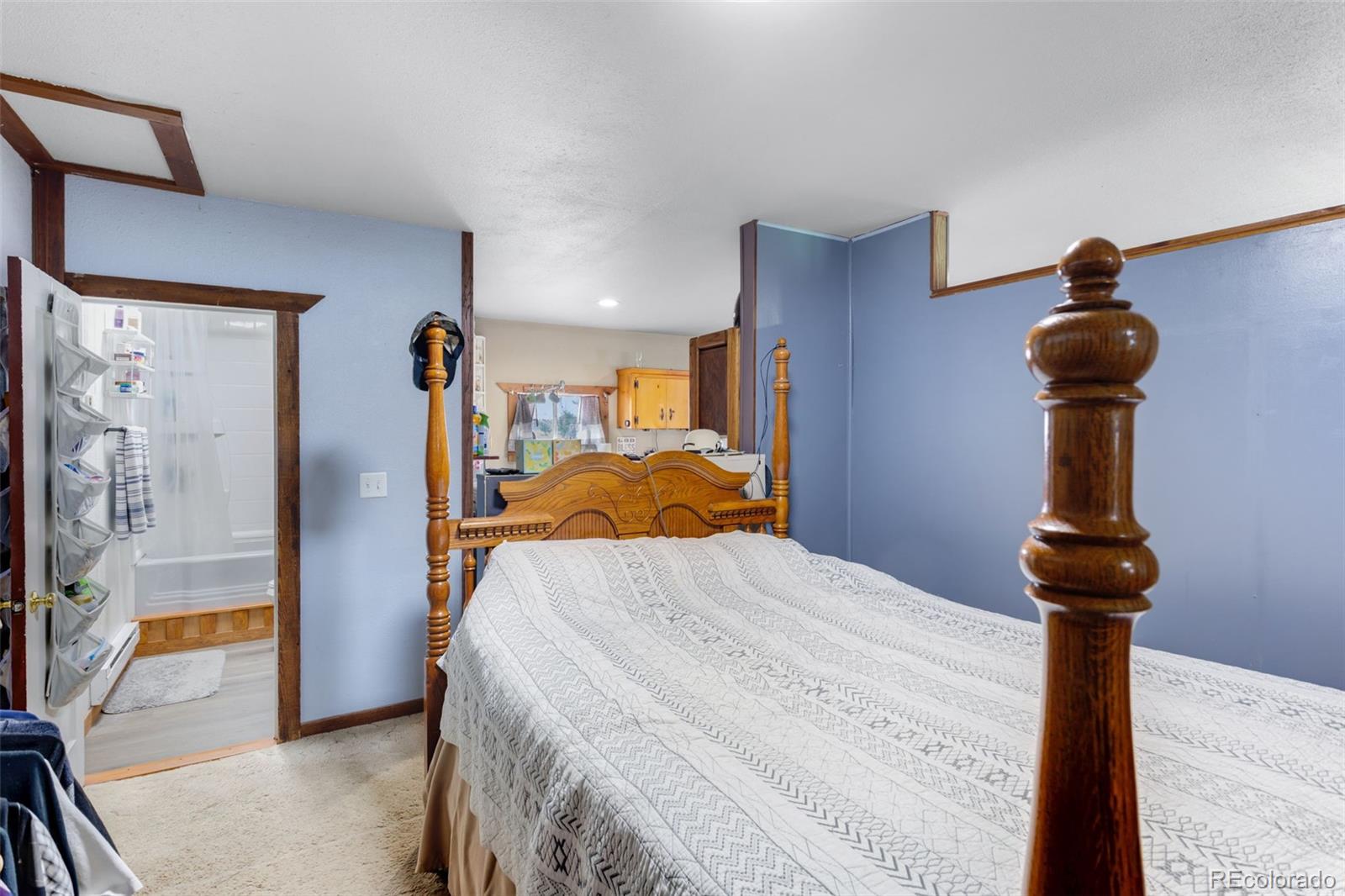 6310 West Co Road 4 Berthoud, CO 80513 - Photo 32 of 49 a bed sitting in a bedroom next to a window