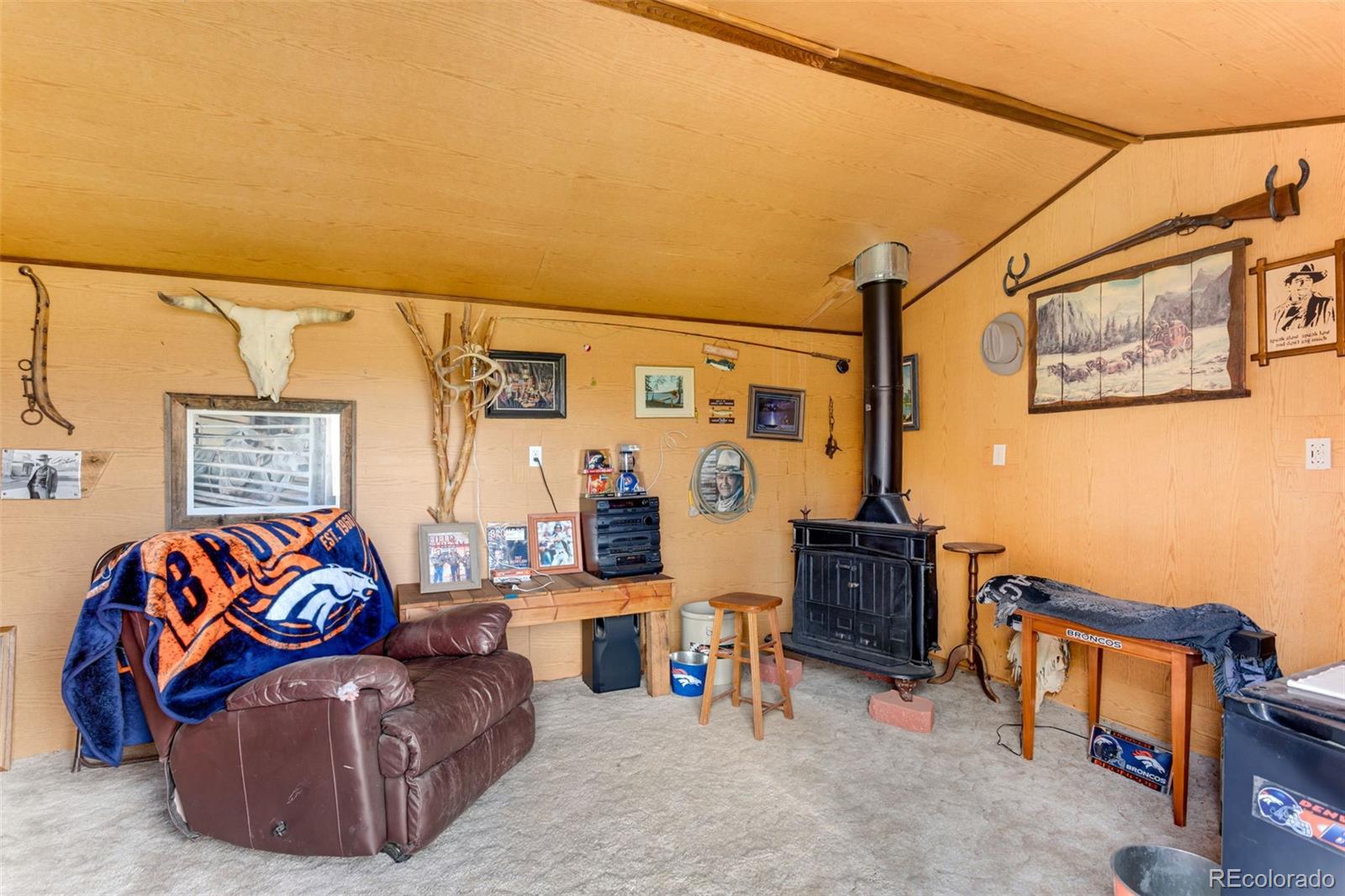 6310 West Co Road 4 Berthoud, CO 80513 - Photo 35 of 49 a living room with furniture a flat screen tv and a couch