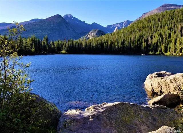 a car parked on the ocean next to a beach