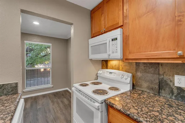 a kitchen with a stove and a microwave