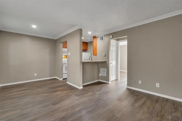 a view of a kitchen with a refrigerator and a sink