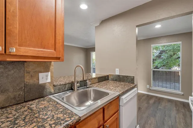 a kitchen with a sink cabinets and window