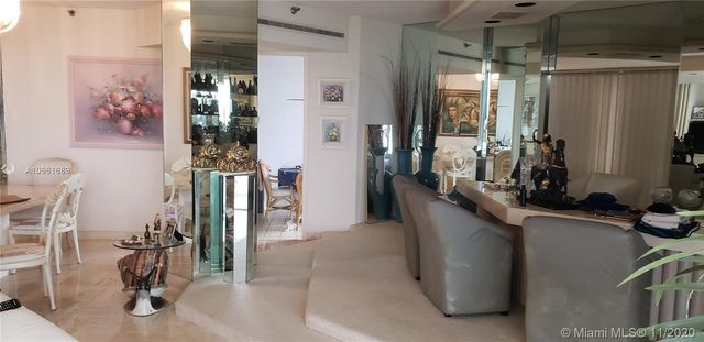 a view of a hallway with workspace and living room